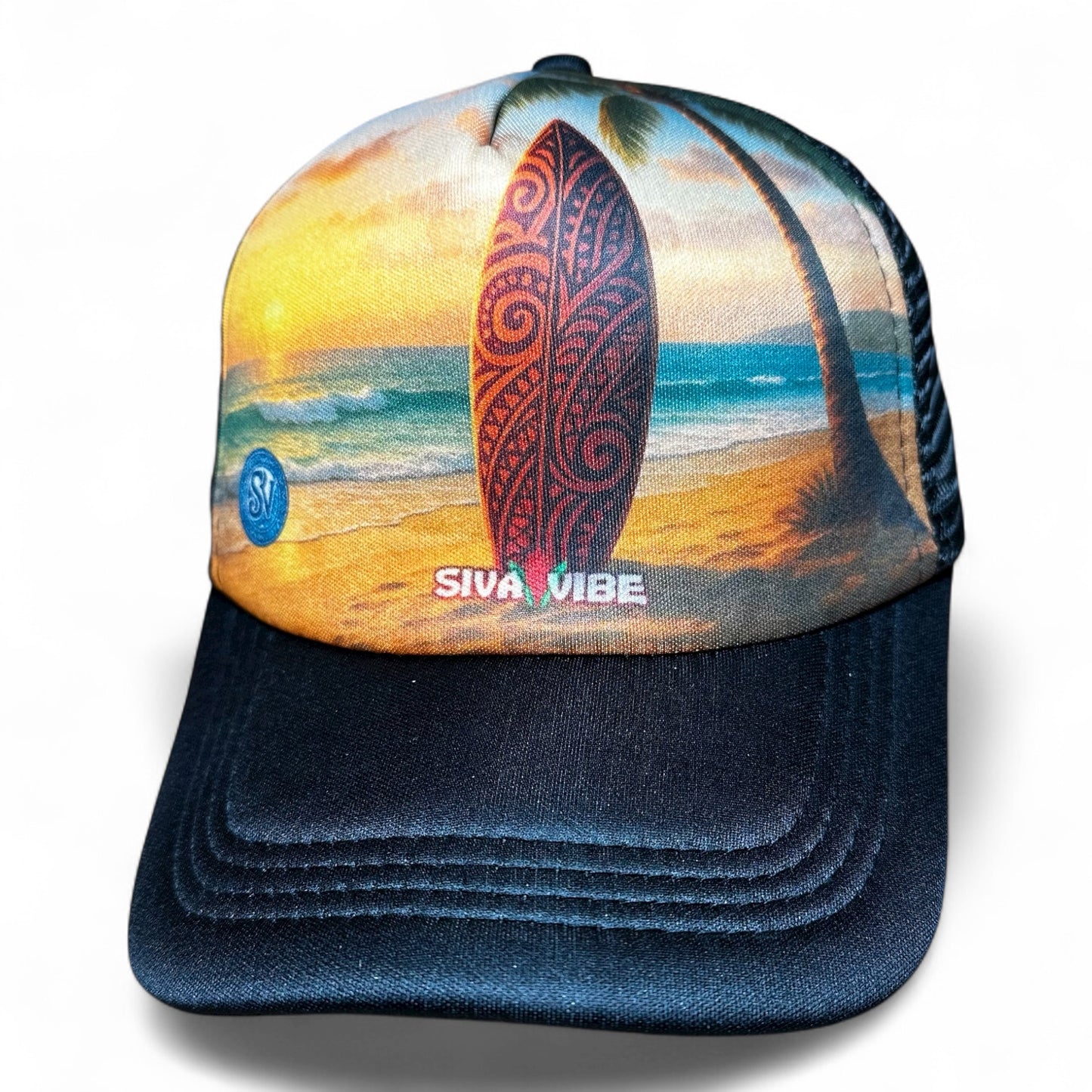 Trucker hat with surfboard on beach at sunset