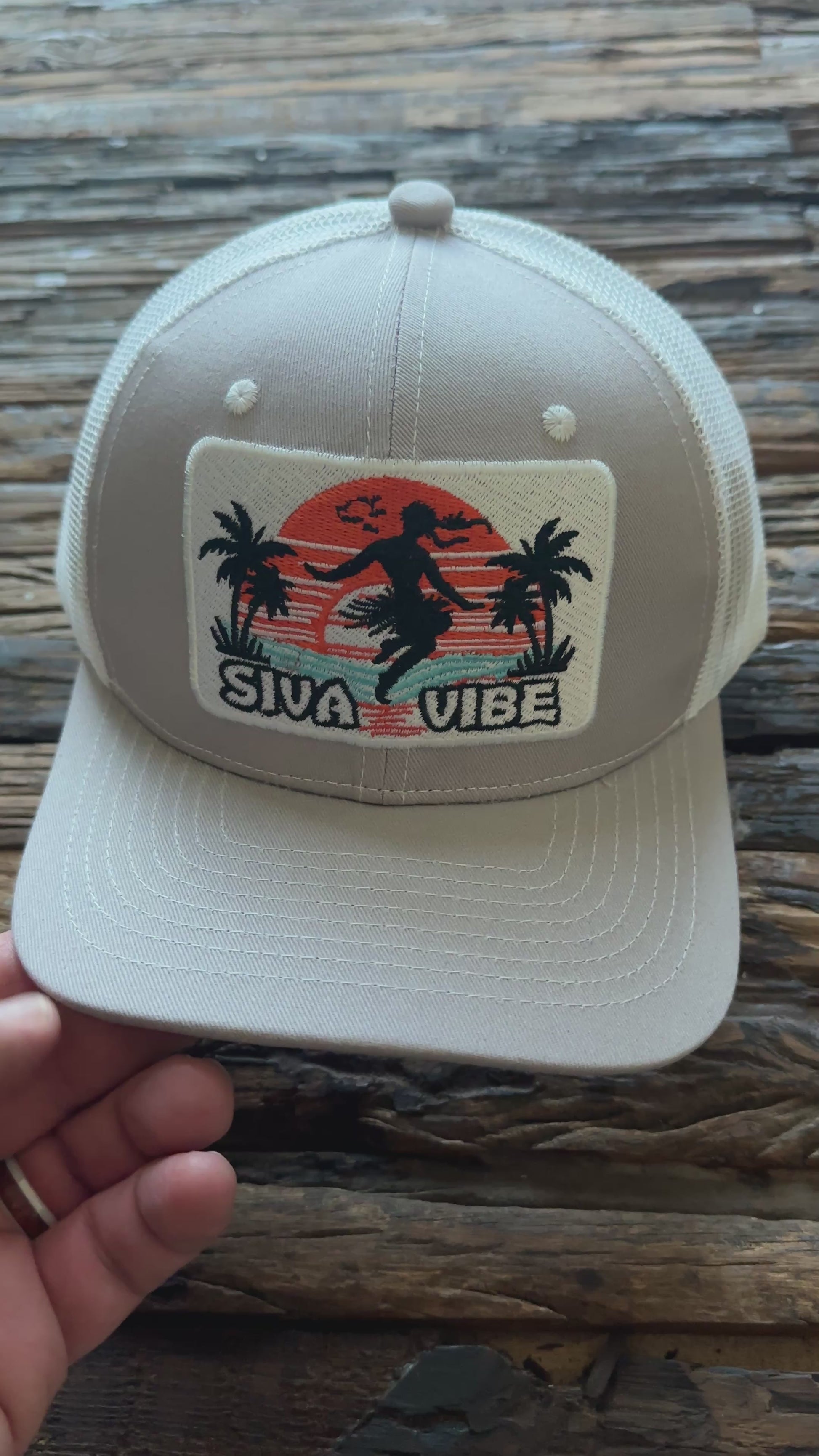 Video of Siva Vibe gray trucker hat spinning to show full view — embroidered island logo and breathable mesh construction