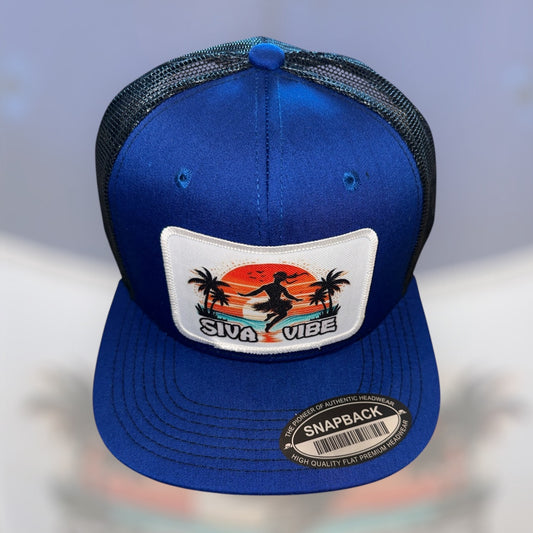 Front view of Siva Vibe royal blue satin hat with embroidered logo patch — hip hop–inspired island fashion