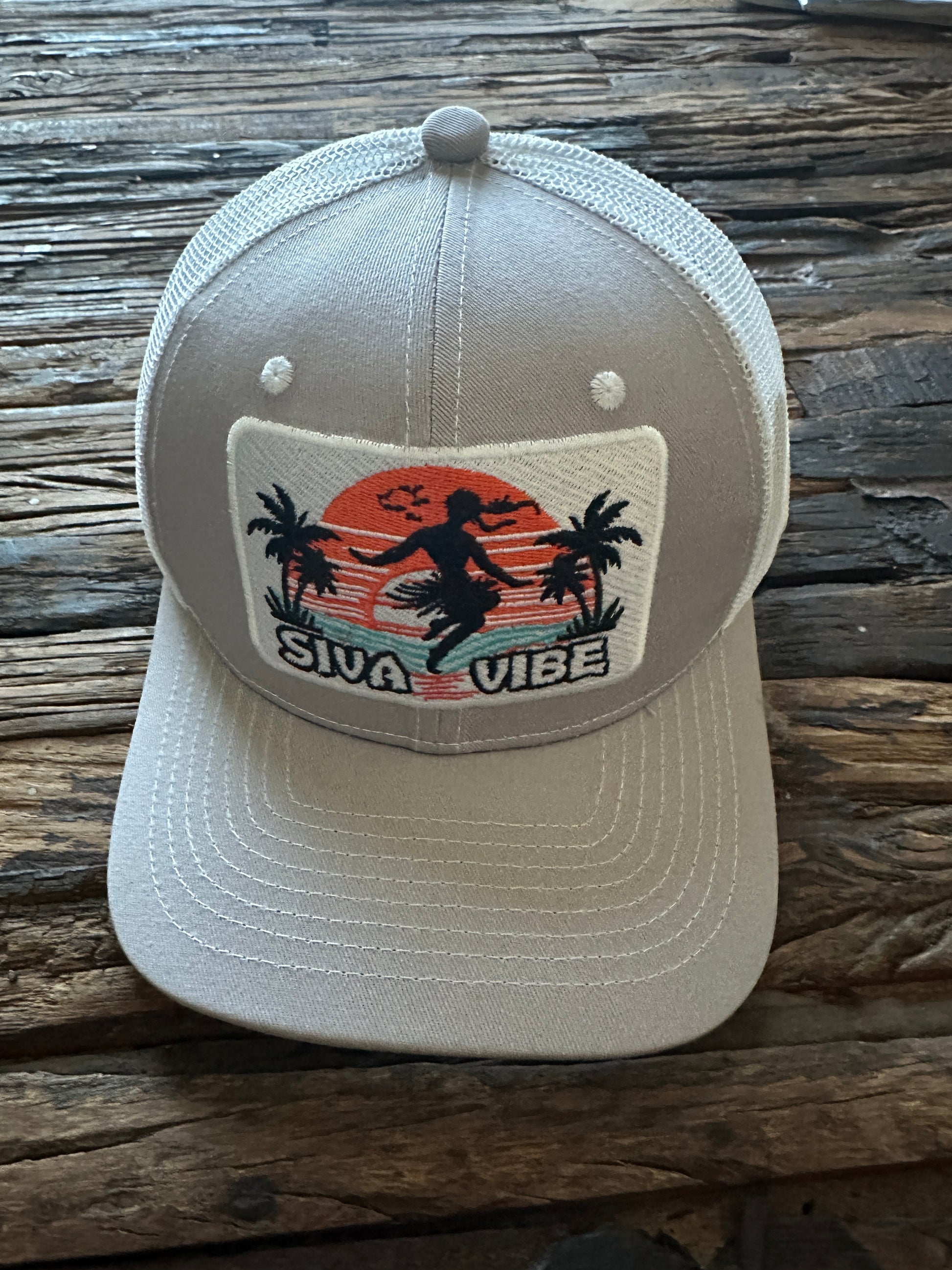 Alternate front angle of Siva Vibe gray embroidered trucker hat — featuring island-inspired design and cotton front panel